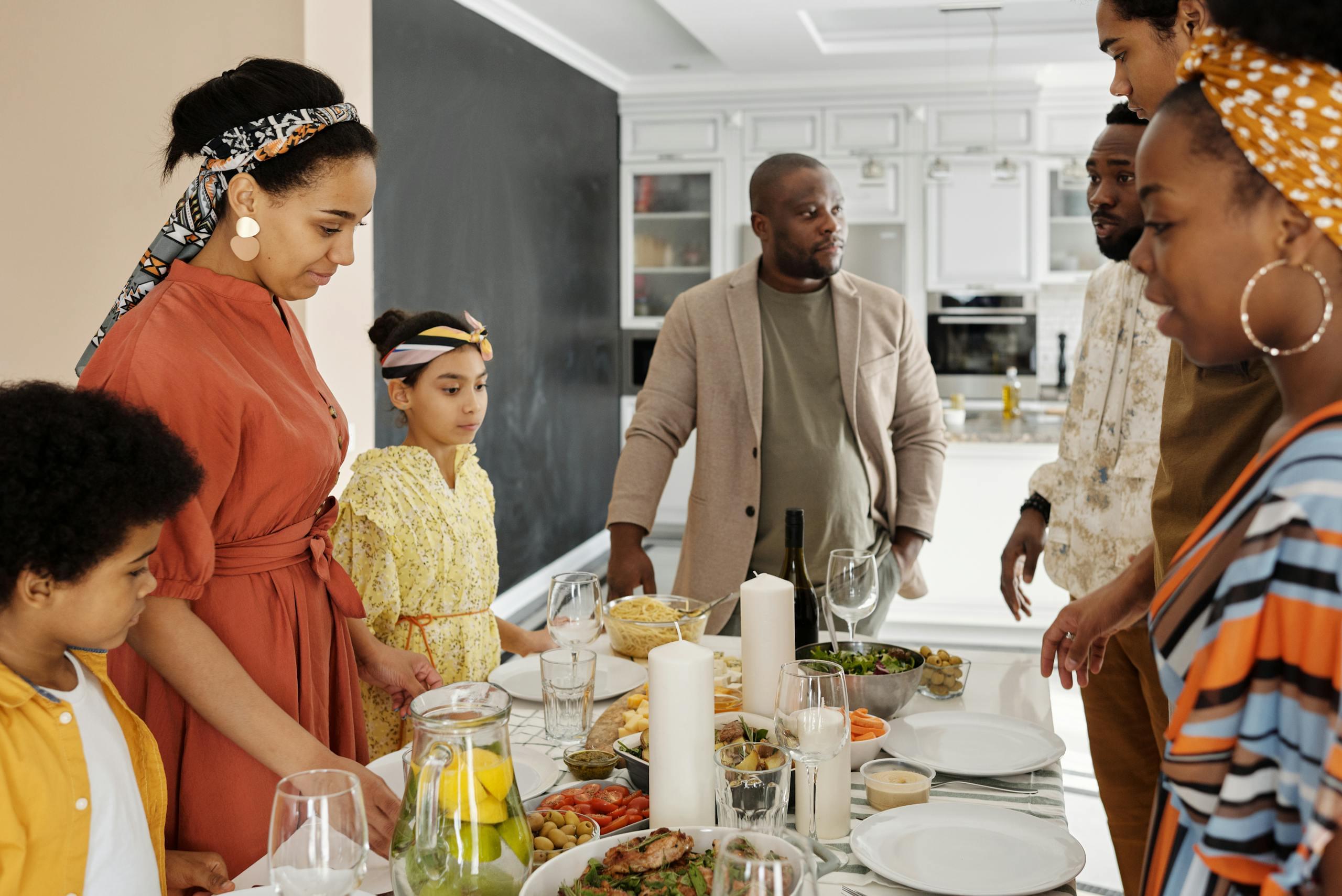A warm family gathering around the table for a meal, sharing joy and togetherness.